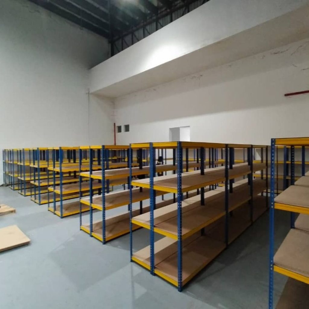 Boltless warehouse racking system with shelves for storing various lightweight items.
