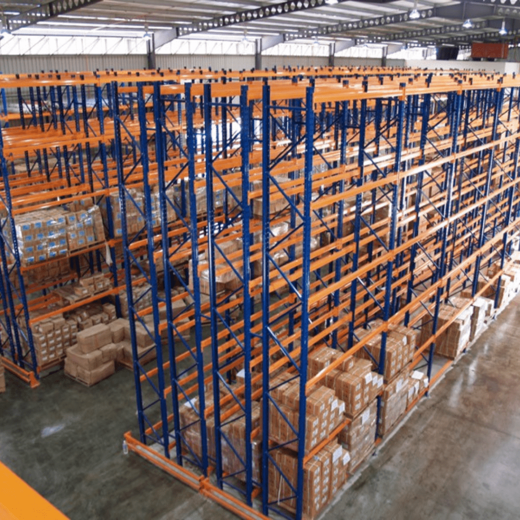 Double-deep warehouse racking system with pallets stored two deep, accessed by a forklift with extended reach forks.